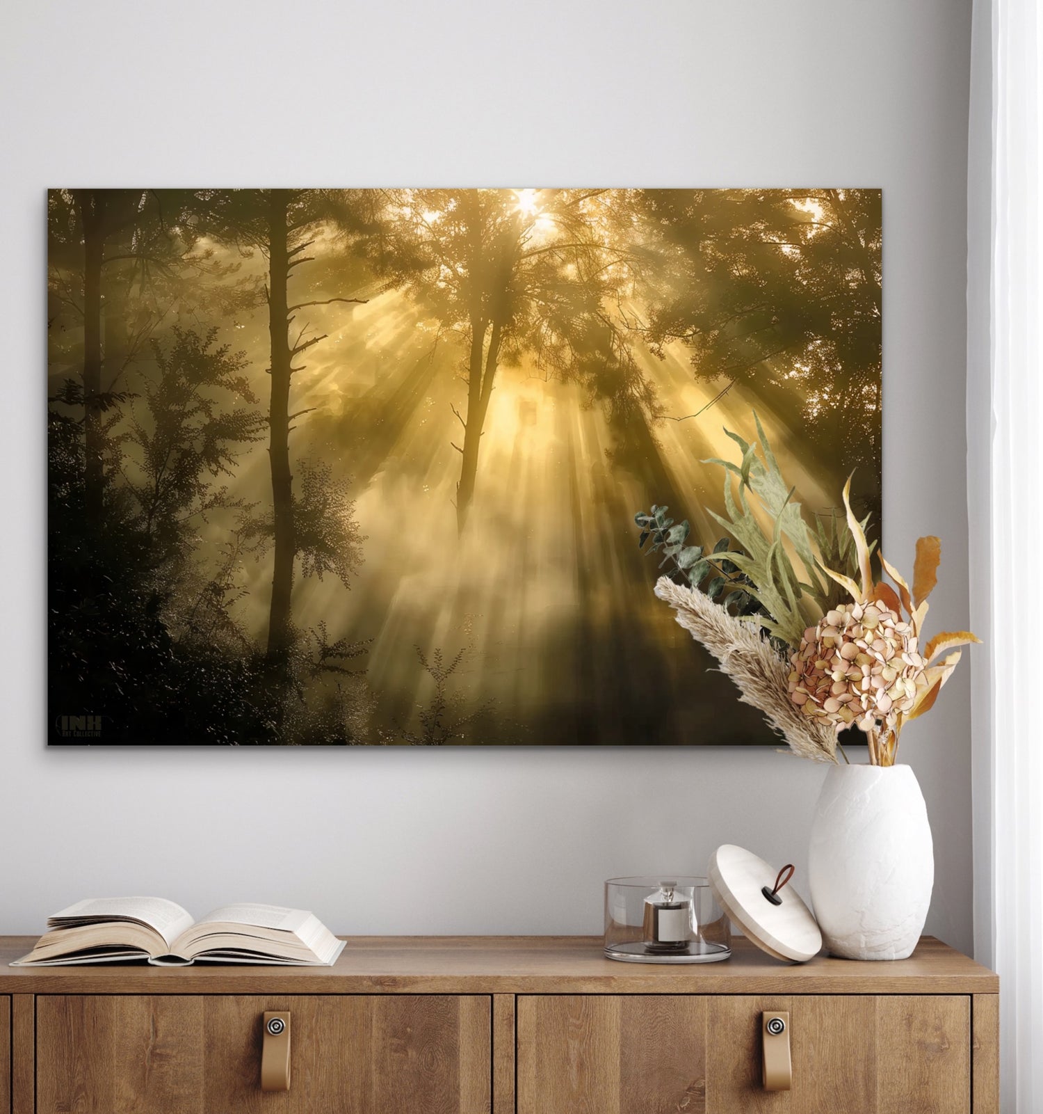 Forest scene with sunlight filtering through trees on a wall above a wooden cabinet with decorative items.