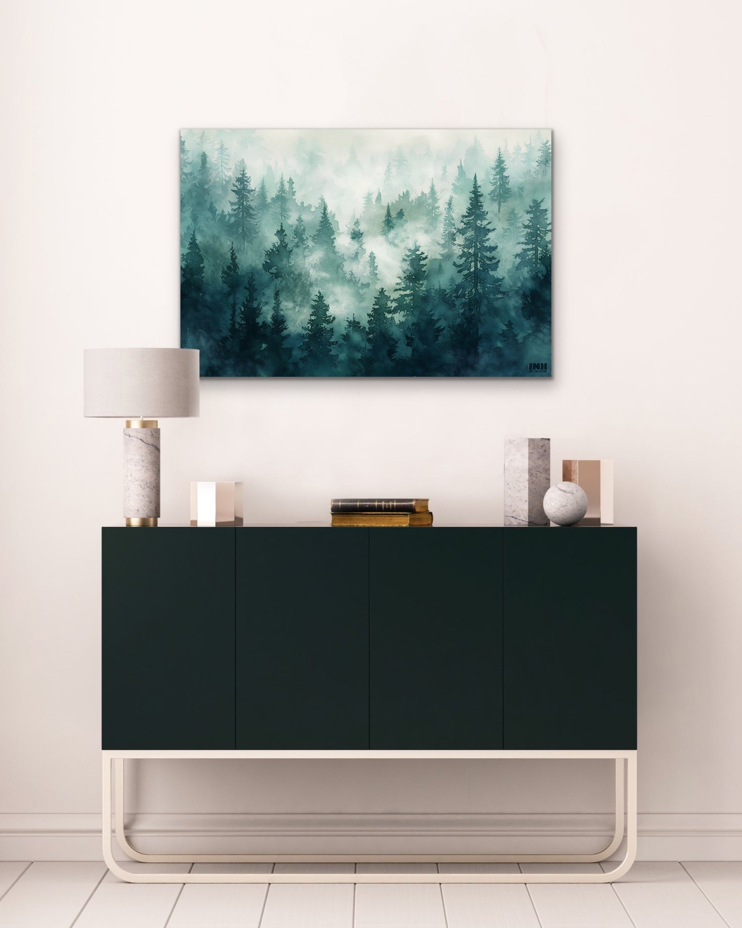Foggy forest painting above a black cabinet in a room with white walls and floor.